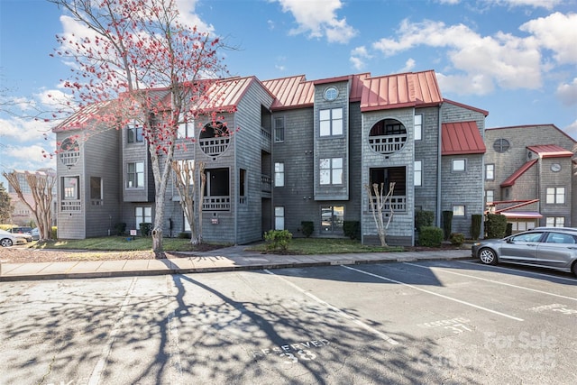 view of building exterior with uncovered parking