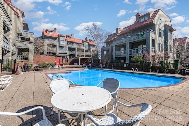 pool featuring a patio and fence