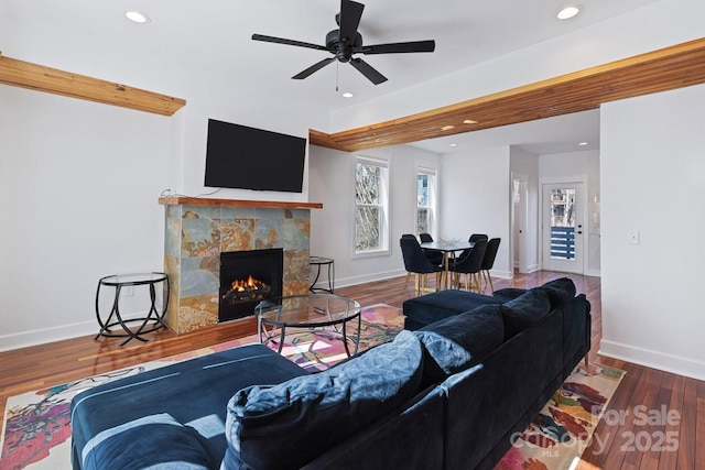 living room featuring wood finished floors, recessed lighting, a fireplace, and baseboards