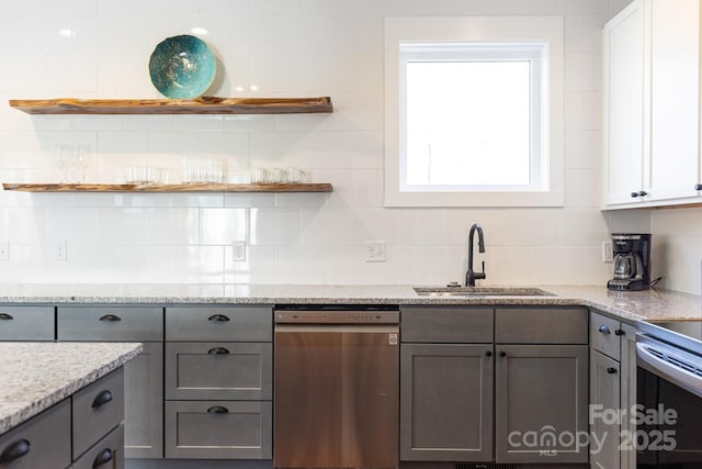 kitchen with open shelves, appliances with stainless steel finishes, gray cabinets, and a sink