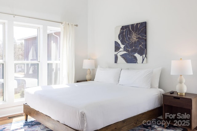 bedroom featuring visible vents and wood finished floors