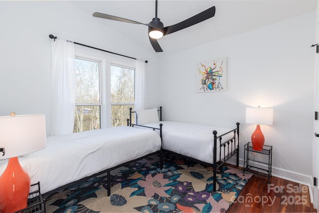 bedroom with ceiling fan, baseboards, and wood finished floors