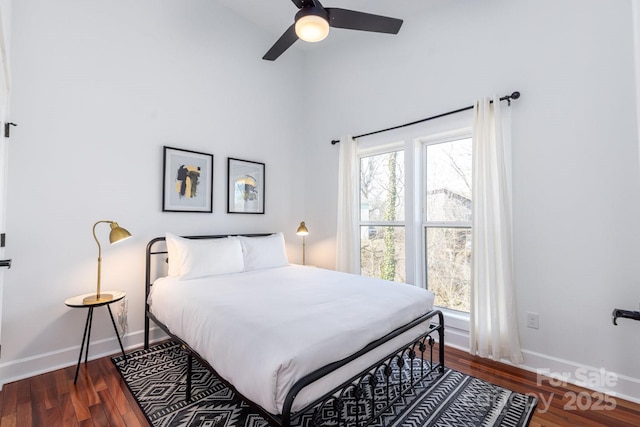 bedroom with baseboards, multiple windows, ceiling fan, and dark wood-style flooring