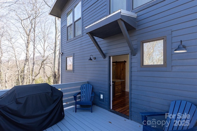 wooden terrace with a grill