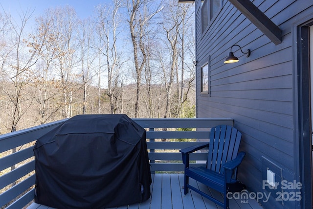 wooden terrace featuring grilling area