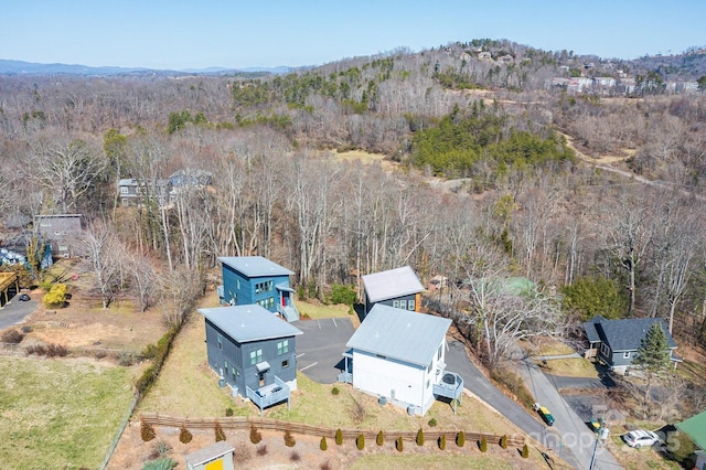 drone / aerial view featuring a forest view