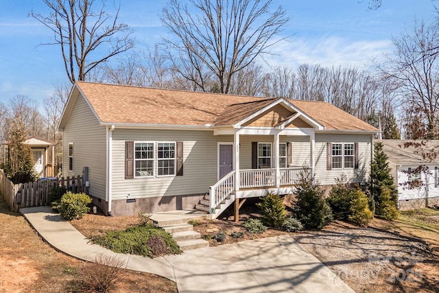 view of front of house with a porch, fence, roof with shingles, and crawl space