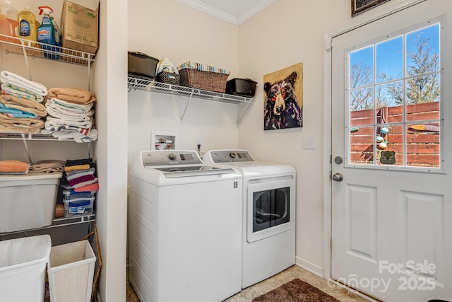 laundry room with washer and dryer, ornamental molding, and laundry area