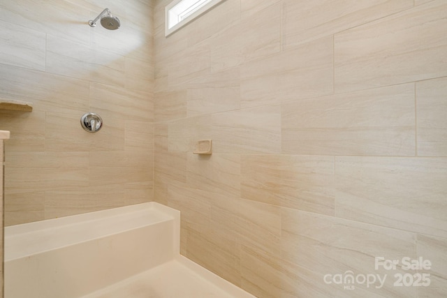 bathroom with a tile shower