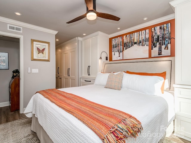 bedroom featuring visible vents, recessed lighting, crown molding, and wood finished floors