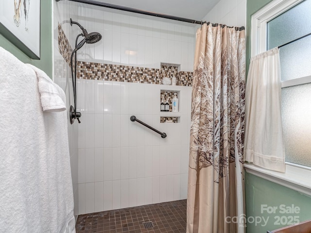 full bathroom with tiled shower