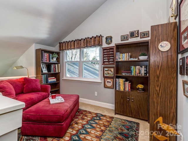 living area featuring baseboards, lofted ceiling, and carpet floors