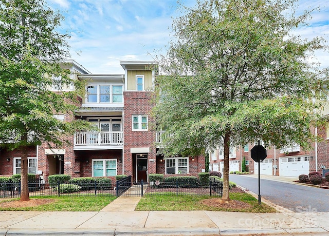 view of property with a fenced front yard and brick siding