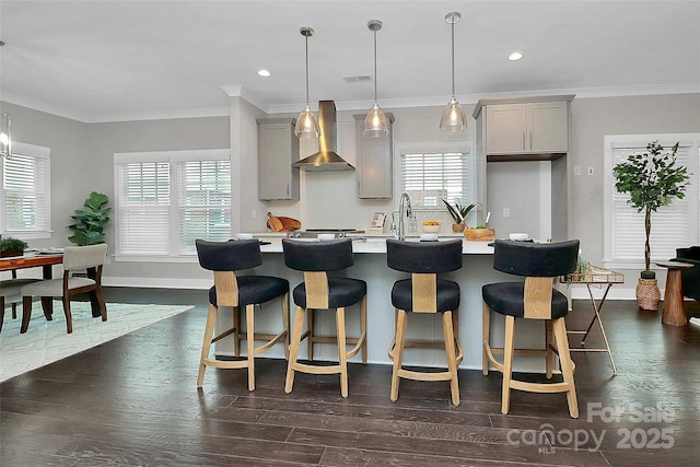 kitchen with visible vents, gray cabinets, light countertops, and wall chimney range hood