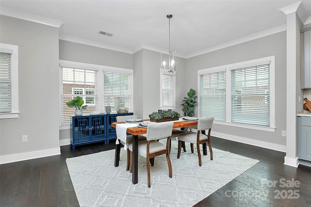 dining room with dark wood finished floors, baseboards, and ornamental molding