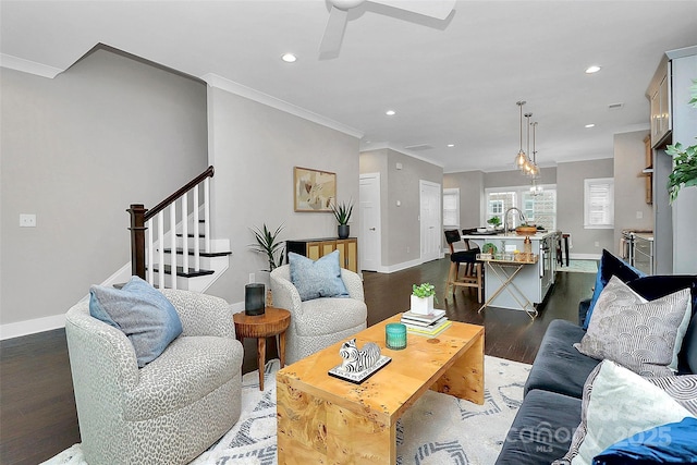 living area featuring stairs, wood finished floors, and baseboards