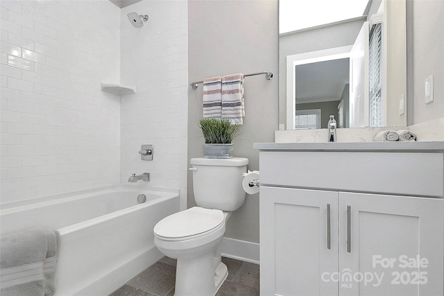 bathroom with baseboards, toilet, shower / bath combination, a skylight, and vanity