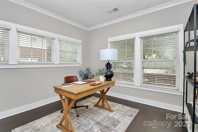 office space with dark wood finished floors, baseboards, visible vents, and ornamental molding