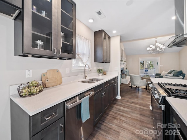 kitchen with a sink, plenty of natural light, dark wood finished floors, and stainless steel appliances