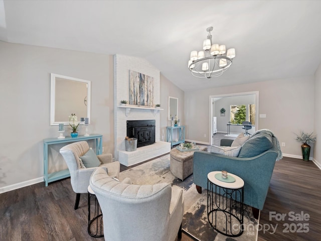 living room with vaulted ceiling, wood finished floors, baseboards, and a chandelier