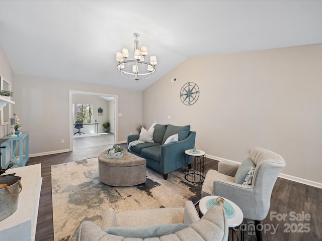 living area featuring vaulted ceiling, a notable chandelier, wood finished floors, and baseboards