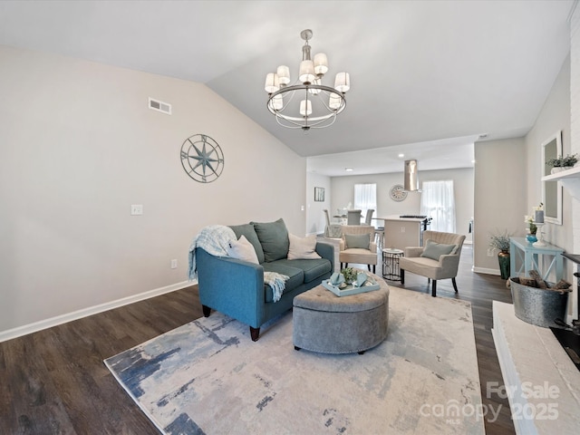 living area featuring visible vents, wood finished floors, an inviting chandelier, baseboards, and vaulted ceiling