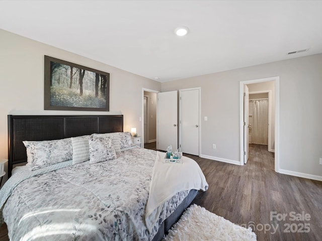 bedroom featuring visible vents, baseboards, and wood finished floors