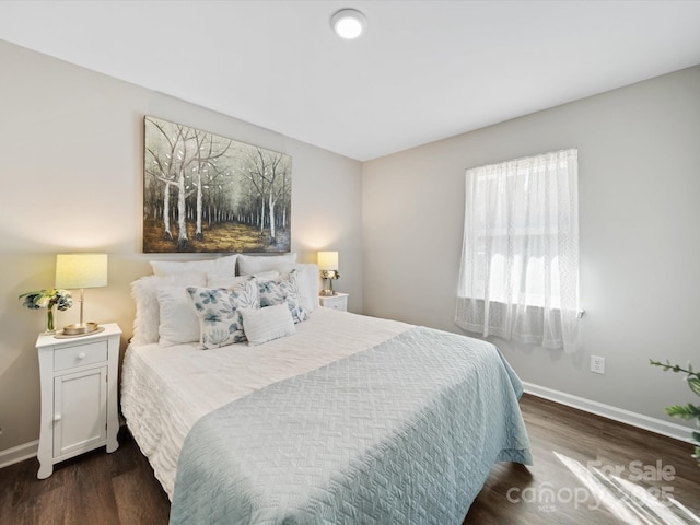 bedroom with wood finished floors and baseboards