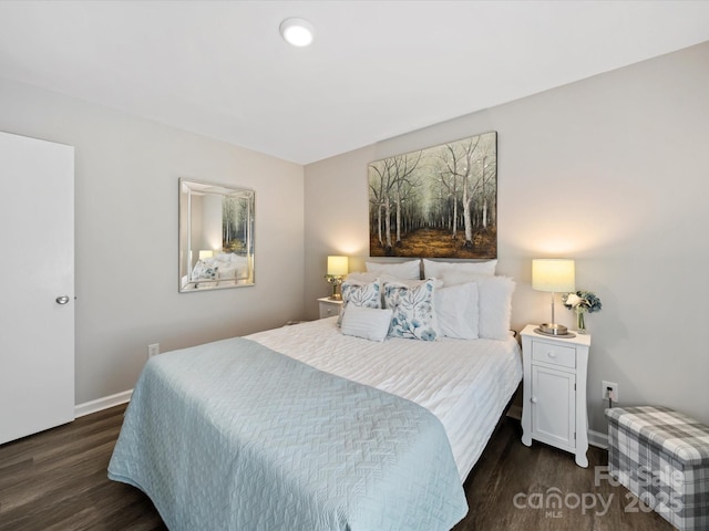 bedroom featuring dark wood-style floors and baseboards