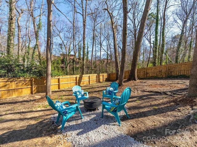 view of yard featuring a fire pit and a fenced backyard