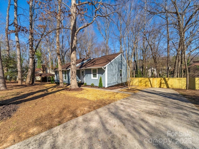 view of front of home with fence and driveway