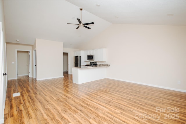 unfurnished living room with light wood finished floors, high vaulted ceiling, baseboards, and ceiling fan