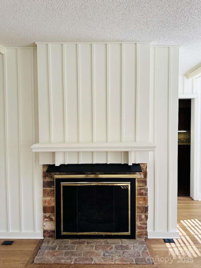 room details with visible vents, a textured ceiling, and a fireplace