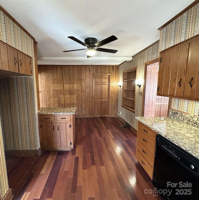 kitchen with wallpapered walls, dishwasher, dark wood-style floors, brown cabinetry, and a textured ceiling