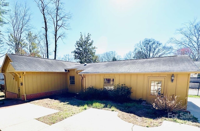 ranch-style home featuring a patio area and board and batten siding