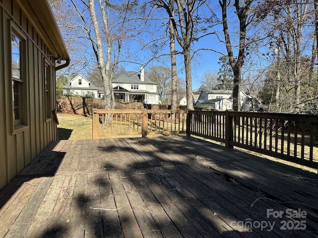 wooden terrace featuring fence