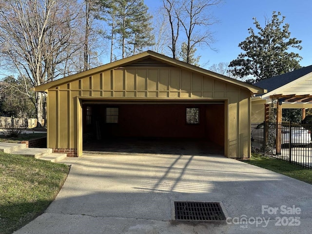 detached garage featuring fence