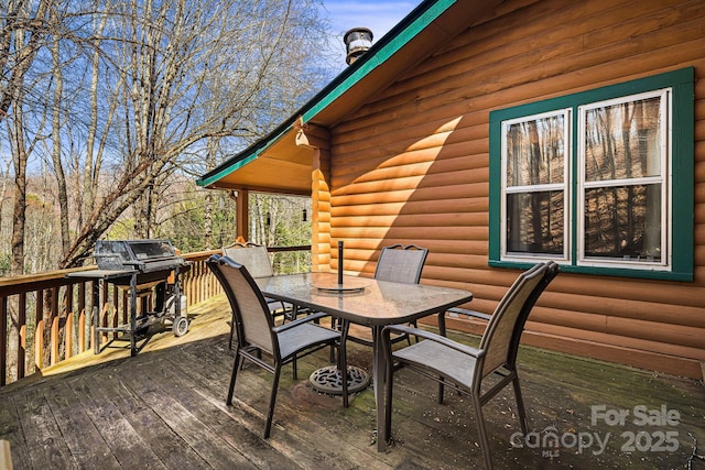 deck featuring area for grilling and outdoor dining space