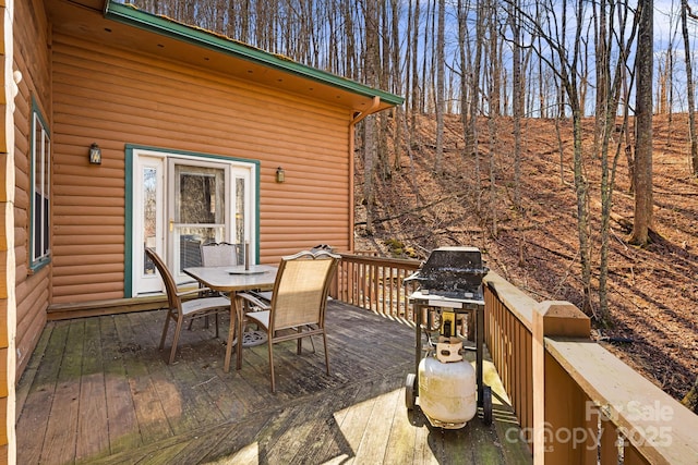 wooden terrace featuring outdoor dining area