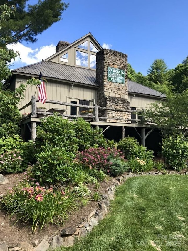 back of property featuring metal roof and a chimney