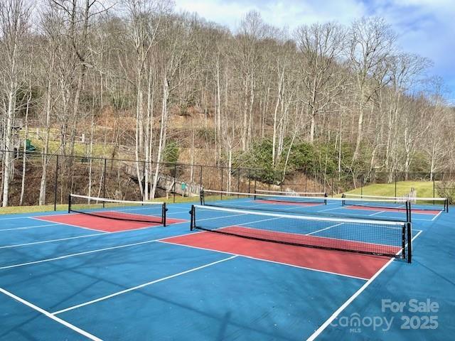 view of sport court featuring community basketball court and fence