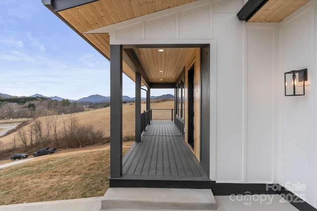 property entrance with a yard and a mountain view