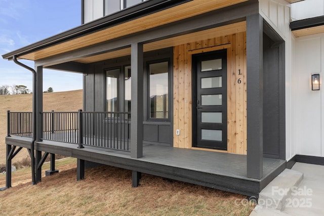 view of exterior entry featuring board and batten siding