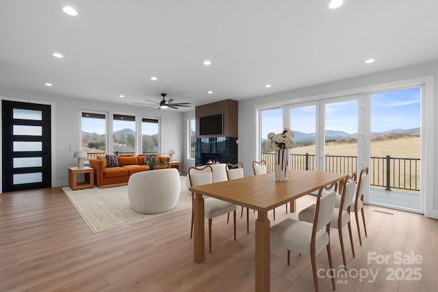 dining space with plenty of natural light, recessed lighting, and light wood-type flooring