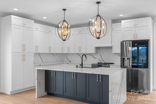 kitchen featuring a sink, appliances with stainless steel finishes, and white cabinets