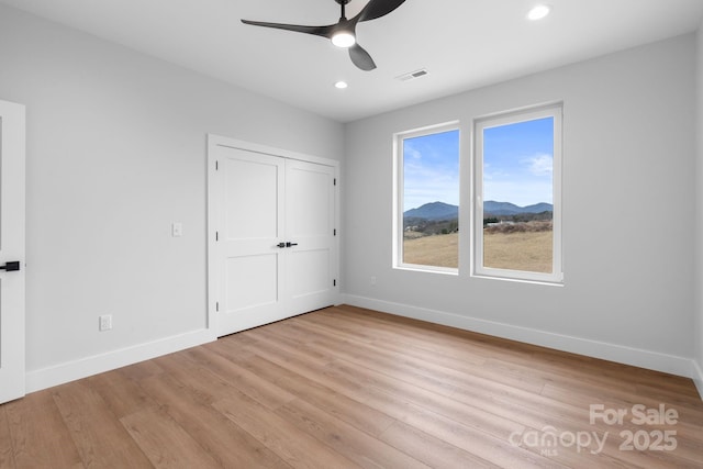 unfurnished bedroom with light wood finished floors, visible vents, recessed lighting, and baseboards