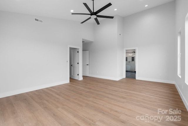 unfurnished room with light wood-type flooring, baseboards, visible vents, and a ceiling fan