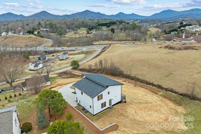 drone / aerial view featuring a mountain view and a rural view