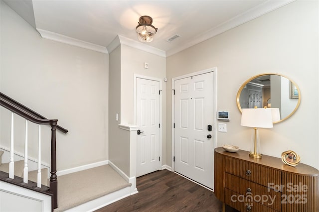 foyer entrance featuring stairway, dark wood-style floors, baseboards, visible vents, and ornamental molding