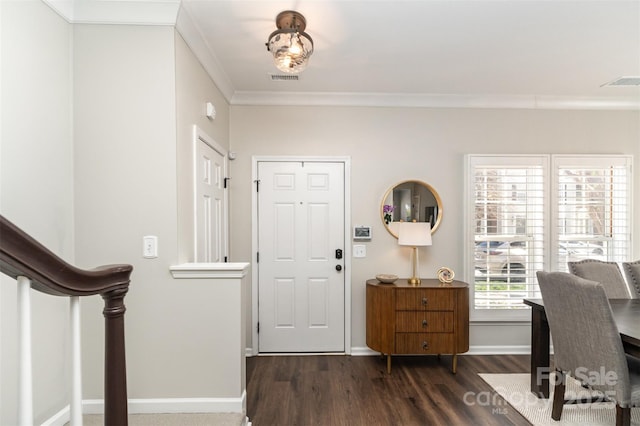 foyer entrance with stairway, wood finished floors, visible vents, baseboards, and crown molding